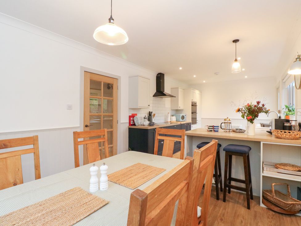 A kitchen with a dining table and chairs at Beechwood Cottage in Blair Atholl