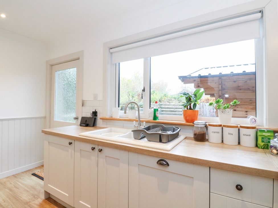 A kitchen with a sink and window at Beechwood Cottage in Blair Atholl