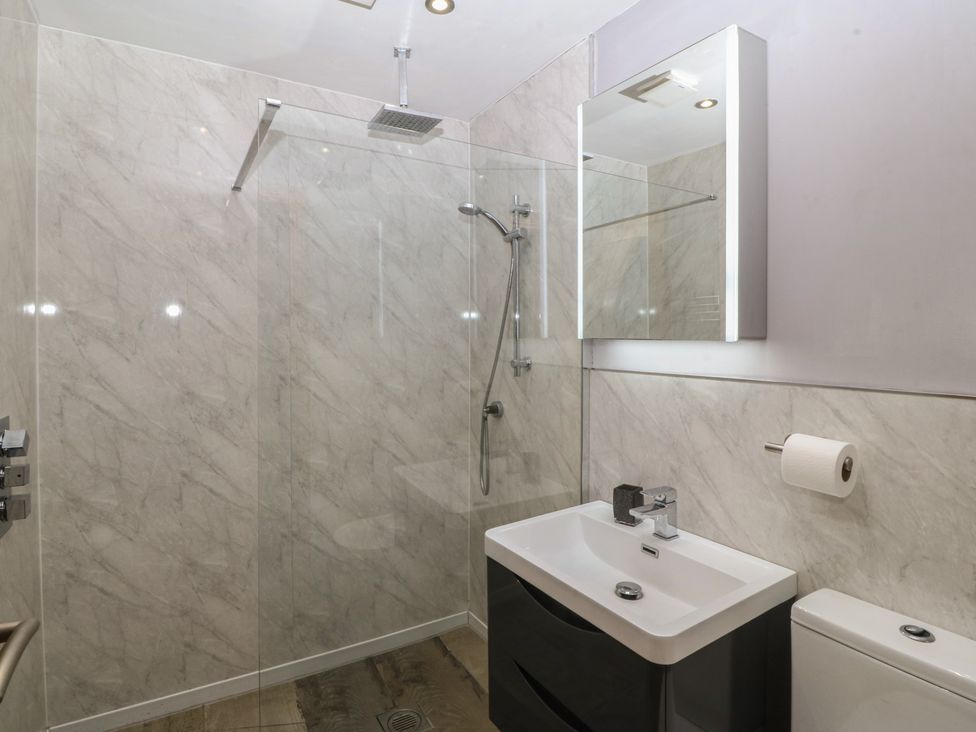 A bathroom with a shower and wash basin at Ty Coch in Llanaelhaearn near Trefor, Caernarfon