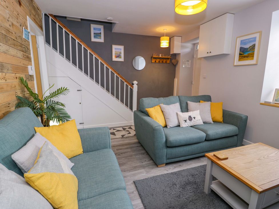 A living room with a sofa and coffee table at Y Bwthyn in Llanbedr