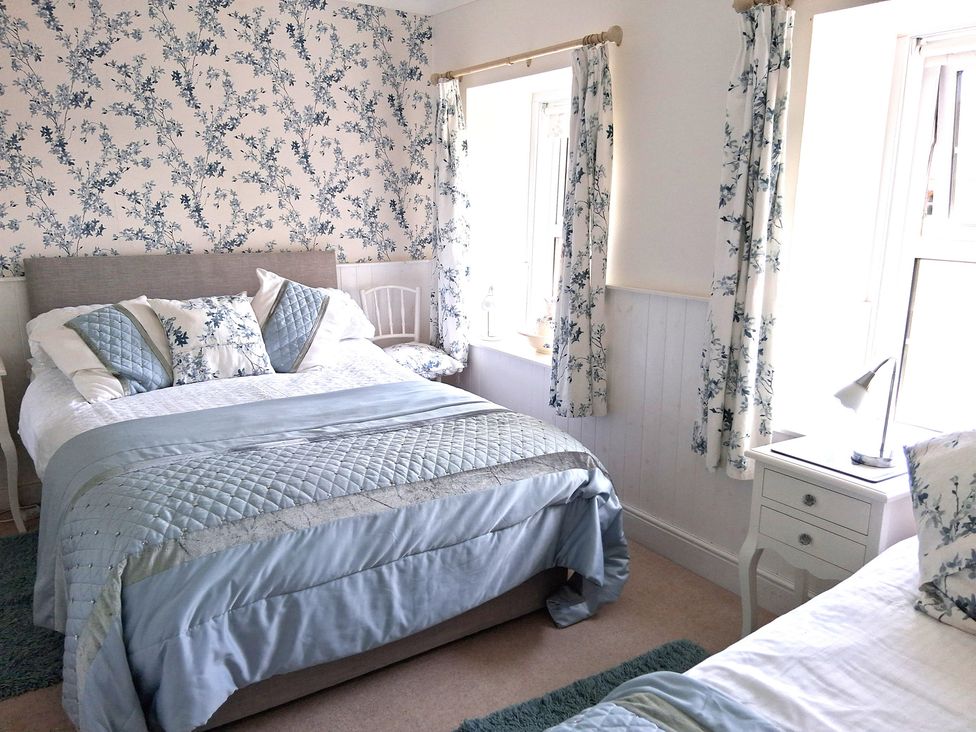 A bedroom with two beds and windows at Crooked Well in Timsbury, Nr Bath