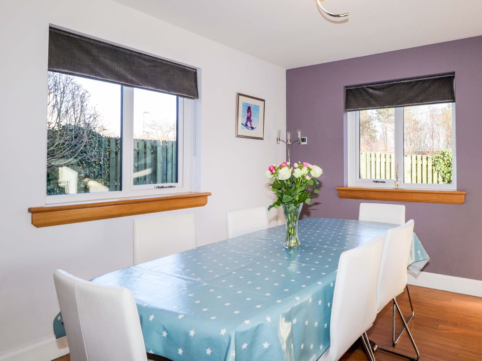 A dining room with a table and chairs at 3 Croftside in Aviemore