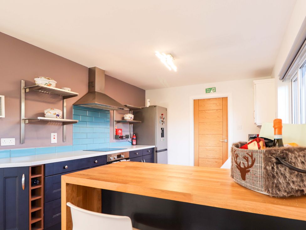 A kitchen with a countertop and appliances at 3 Croftside, Aviemore