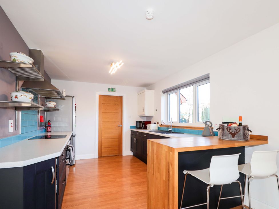 A kitchen with cabinets and a sink at 3 Croftside in Aviemore