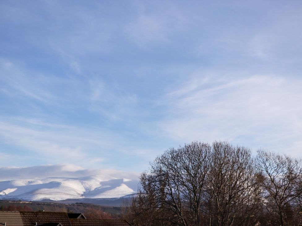 A view of mountains and trees with a clear sky at 3 Croftside in Aviemore