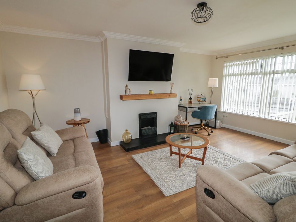 A living room with a sofa and coffee table at Hazel Cottage Portrush