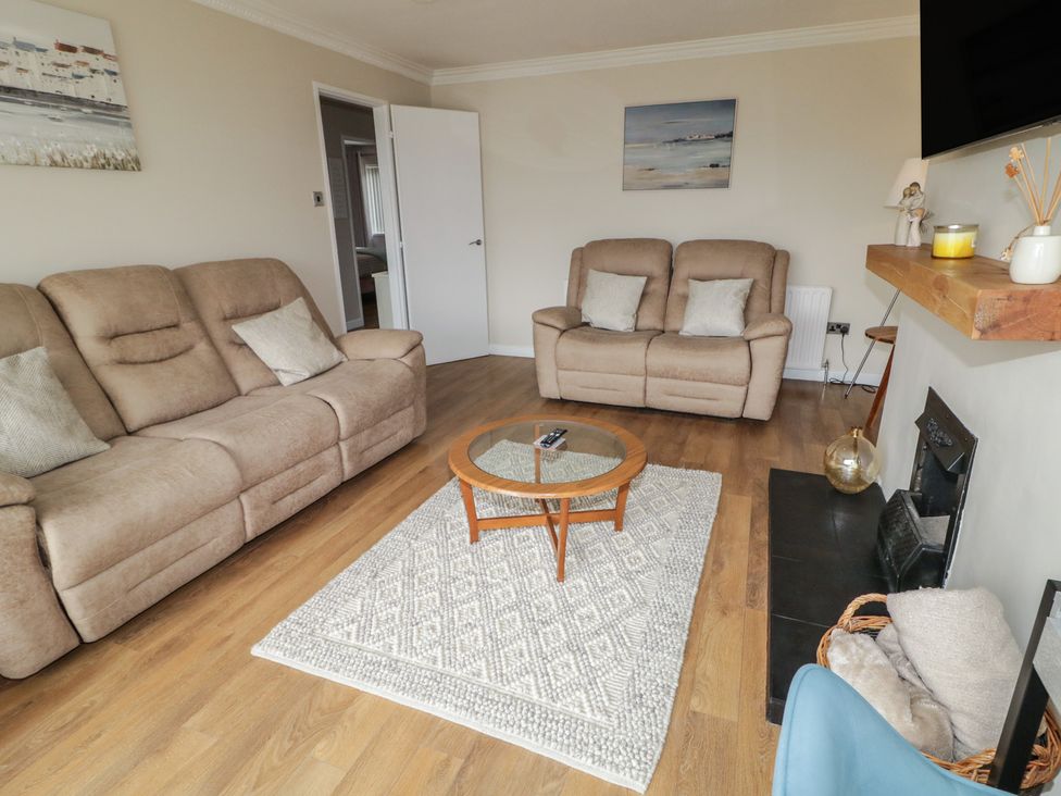 A living room with sofas and a coffee table at Hazel Cottage Portrush
