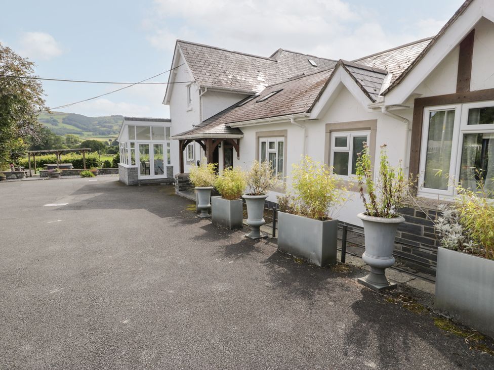 An outdoor area with a house and planters at Pengwern in Llanrwst