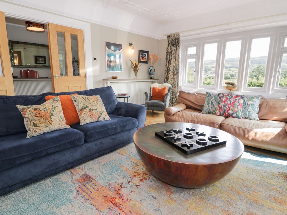 A living room with sofas and a coffee table at Pengwern in Llanrwst