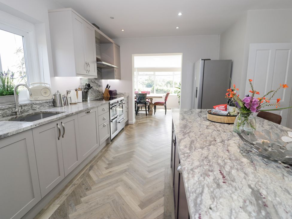 A kitchen with appliances and a dining area at Pengwern Llanrwst