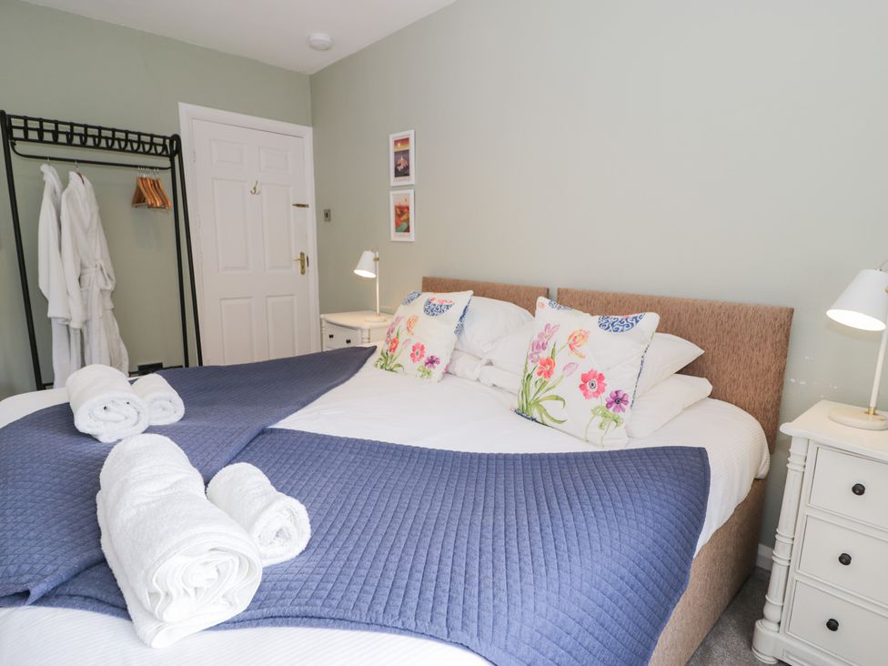 A bedroom with a double bed and bedside table at Pengwern in Llanrwst