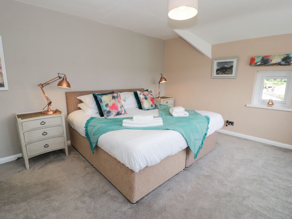 A bedroom with a bed and bedside table at Pengwern in Llanrwst