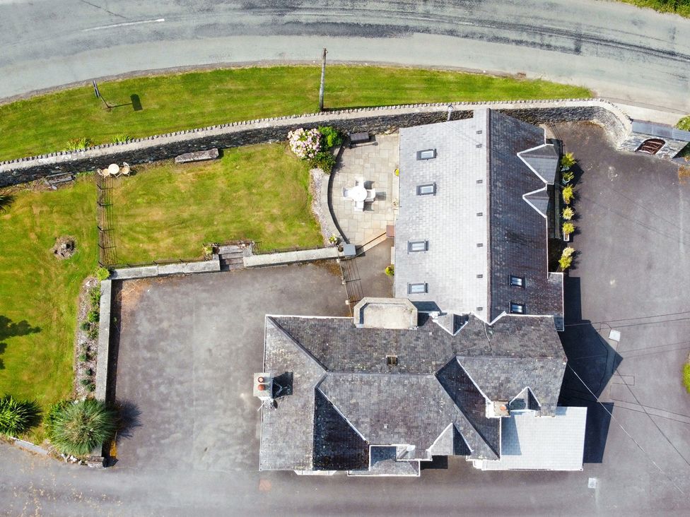 An aerial view of a house with a garden and patio at Pengwern in Llanrwst