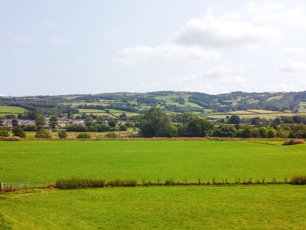 A view of green fields and hills at Pengwern in Llanrwst