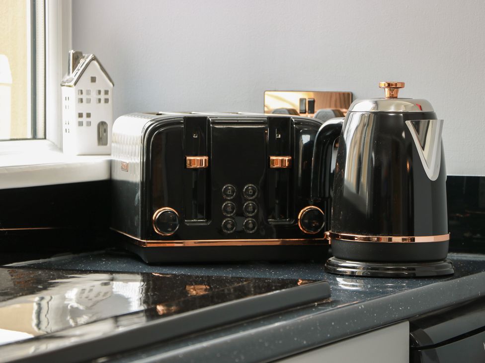 A kettle and toaster on a countertop at Shotts Cottage in Stirling