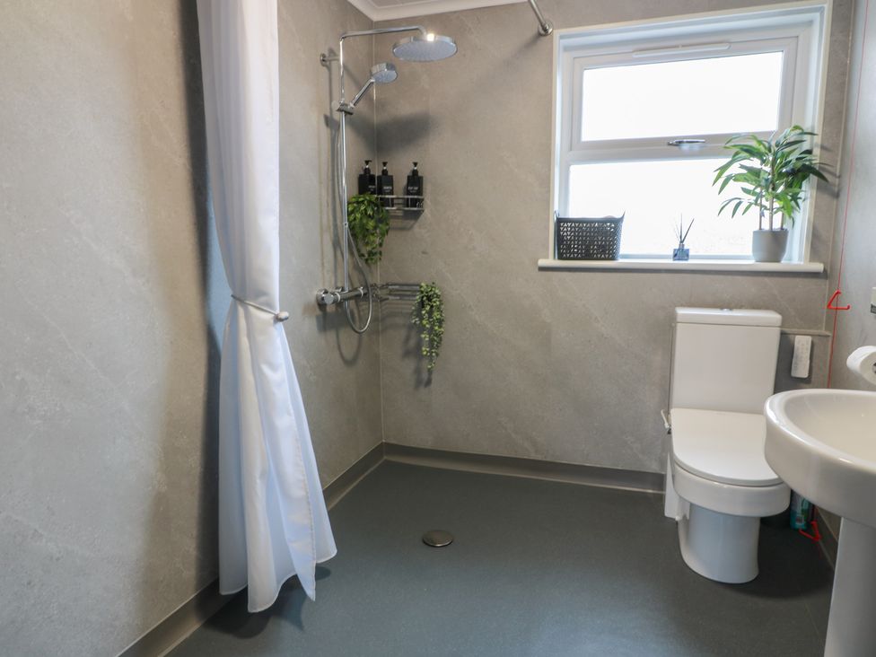 A bathroom with a shower and toilet at Shotts Cottage Stirling