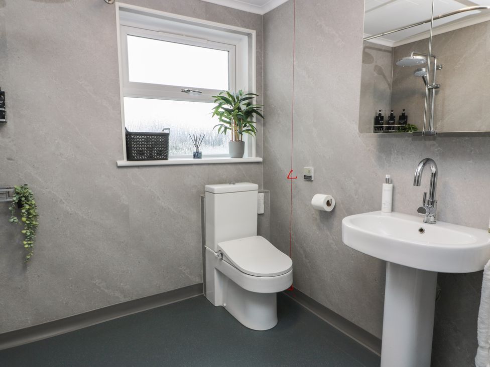 A bathroom with a toilet and sink at Shotts Cottage in Stirling