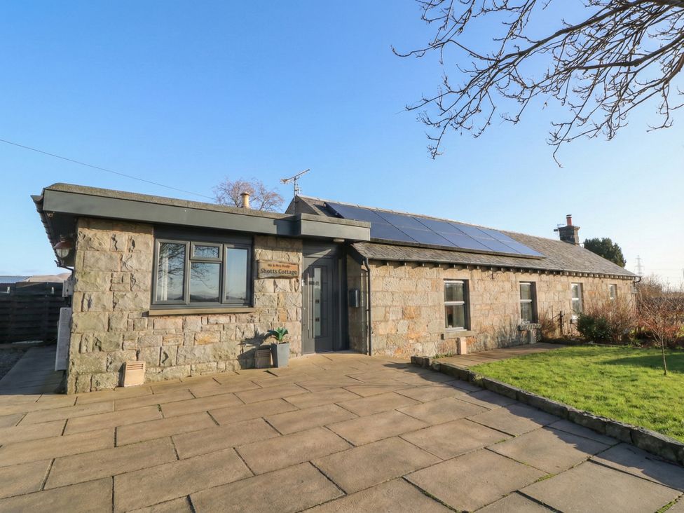 A house with solar panels and a garden at Shotts Cottage in Stirling