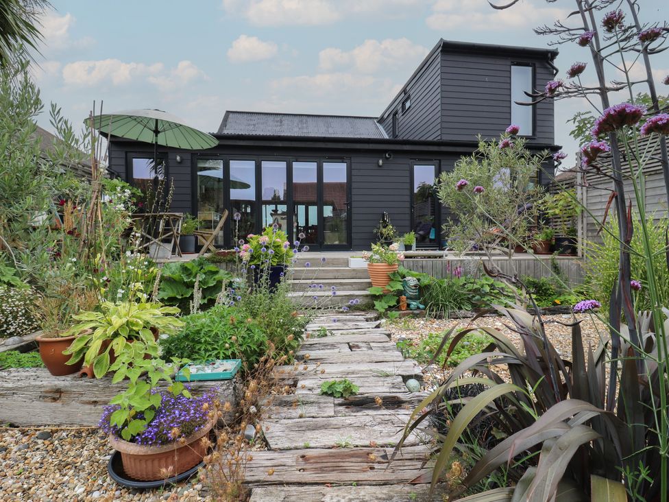 A garden with plants and a wooden pathway at The Artists House by The Sea in Herne Bay