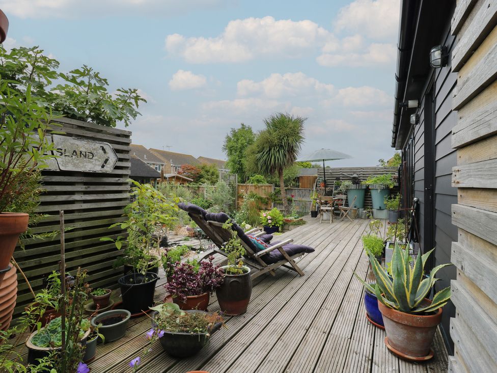 A garden area with planters and seating at The Artists House by The Sea Herne Bay