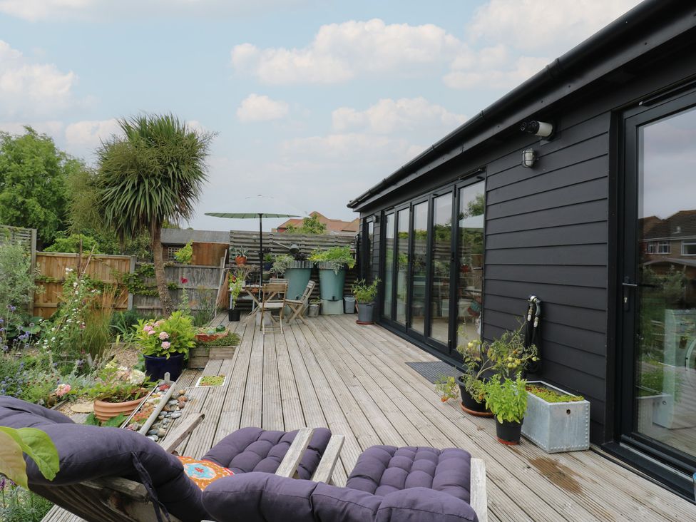 A garden with decking and furniture at The Artists House by The Sea Herne Bay