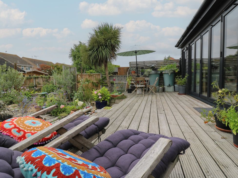 A garden patio with chairs and plants at The Artists House by The Sea Herne Bay