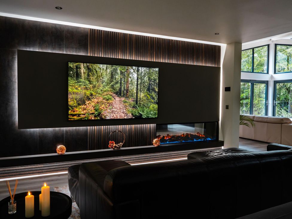A living room with a television and fireplace at Heilan Roo Killiecrankie near Pitlochry and Blair Atholl