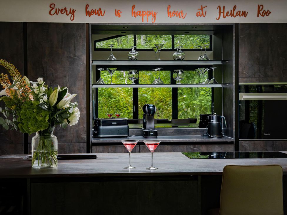 A kitchen with flowers and cocktails at Heilan Roo Killiecrankie near Pitlochry and Blair Atholl