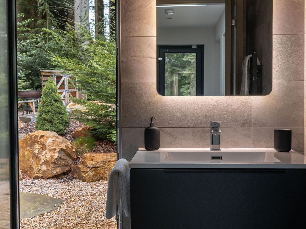 A bathroom with a sink and mirror at Heilan Roo Killiecrankie near Pitlochry and Blair Atholl
