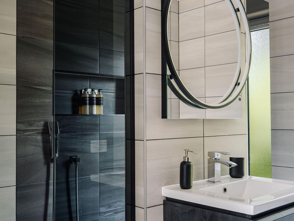 A bathroom with a sink and shower area at Heilan Roo in Killiecrankie near Pitlochry and Blair Atholl