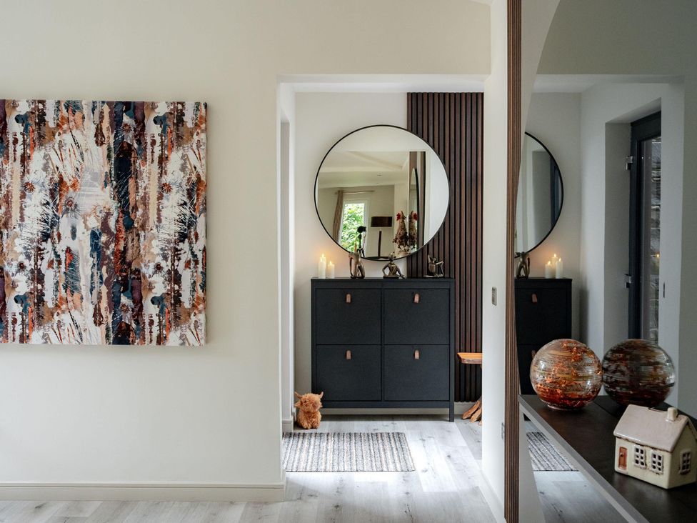 A hallway with a mirror and chest of drawers at Heilan Roo Killiecrankie near Pitlochry and Blair Atholl