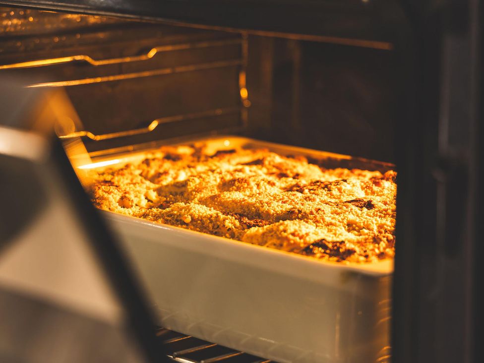 A baking dish with food inside an oven at Heilan Roo near Killiecrankie and Pitlochry and Blair Atholl