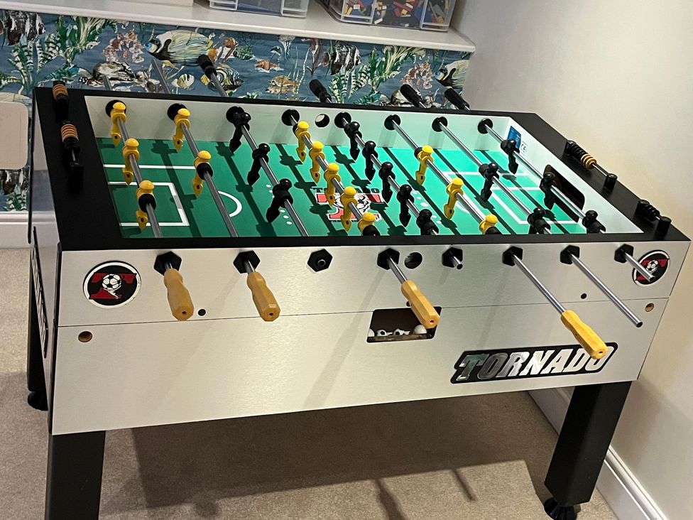 A foosball table with yellow and black players at Seasides in Weymouth