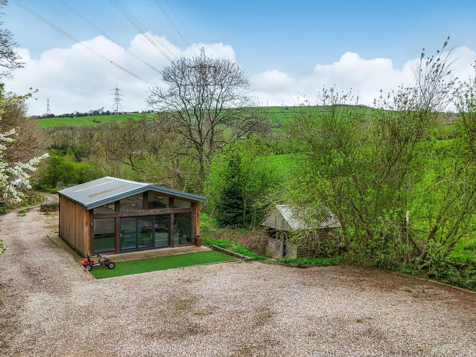 An outdoor area with a building and trees at Belvedere Farm in Hipperholme