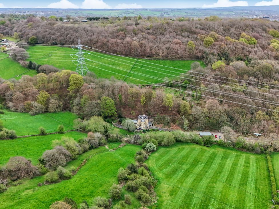 An aerial view of fields and a house at Belvedere Farm in Hipperholme