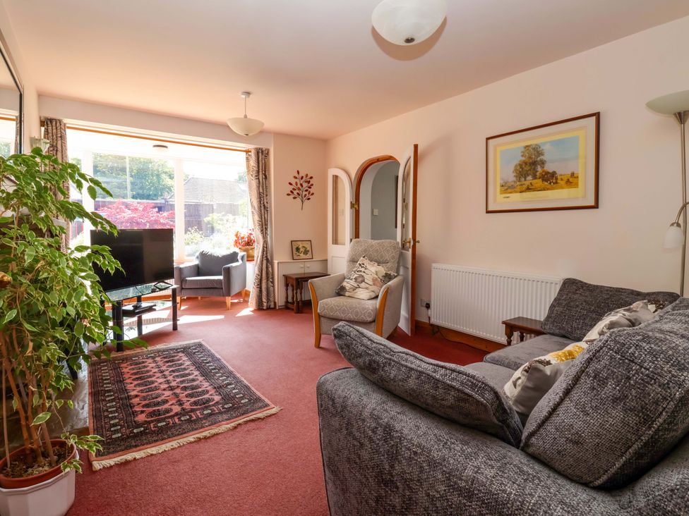 A living room with a sofa and television at 3 Springhaven in Hampsthwaite