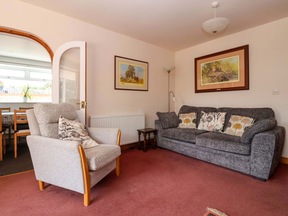 A living room with an armchair and sofa at 3 Springhaven Hampsthwaite