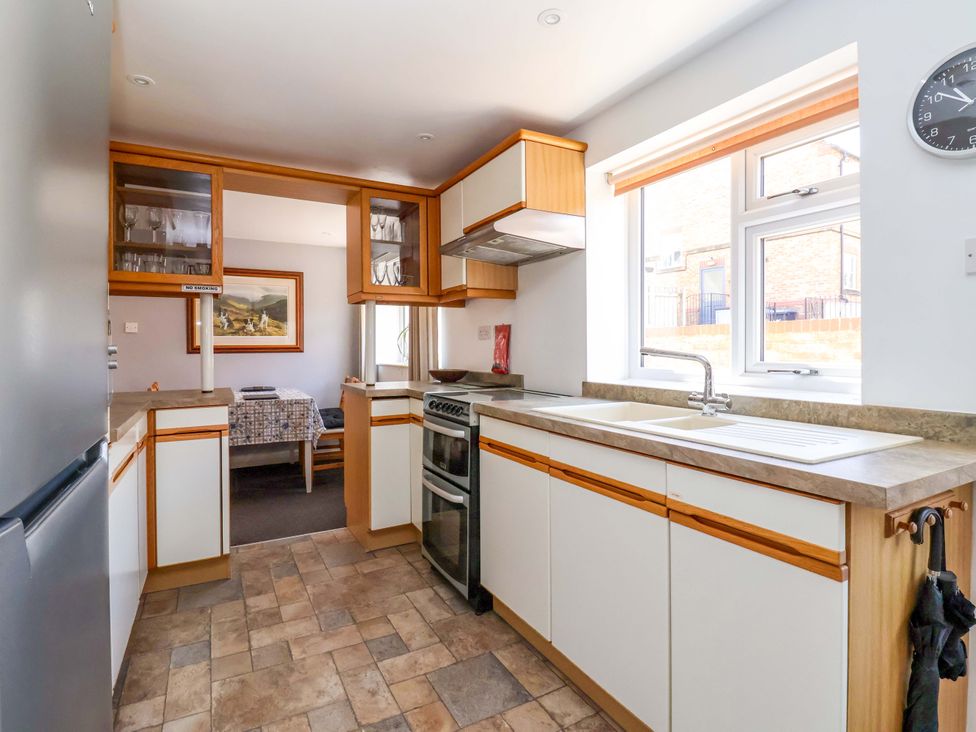 A kitchen with cabinets, stove, and sink at 3 Springhaven Hampsthwaite