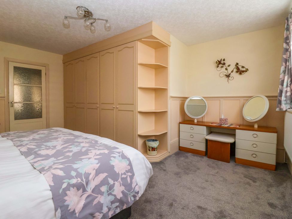 A bedroom with a bed and dresser at 3 Springhaven Hampsthwaite