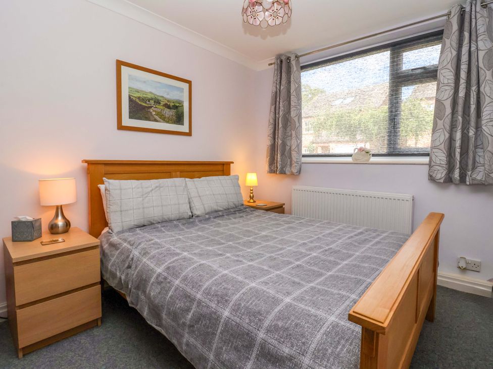 A bedroom with a bed and bedside table at 3 Springhaven in Hampsthwaite