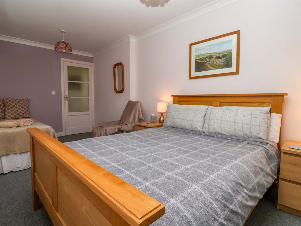 A bedroom with a bed and nightstand at 3 Springhaven in Hampsthwaite