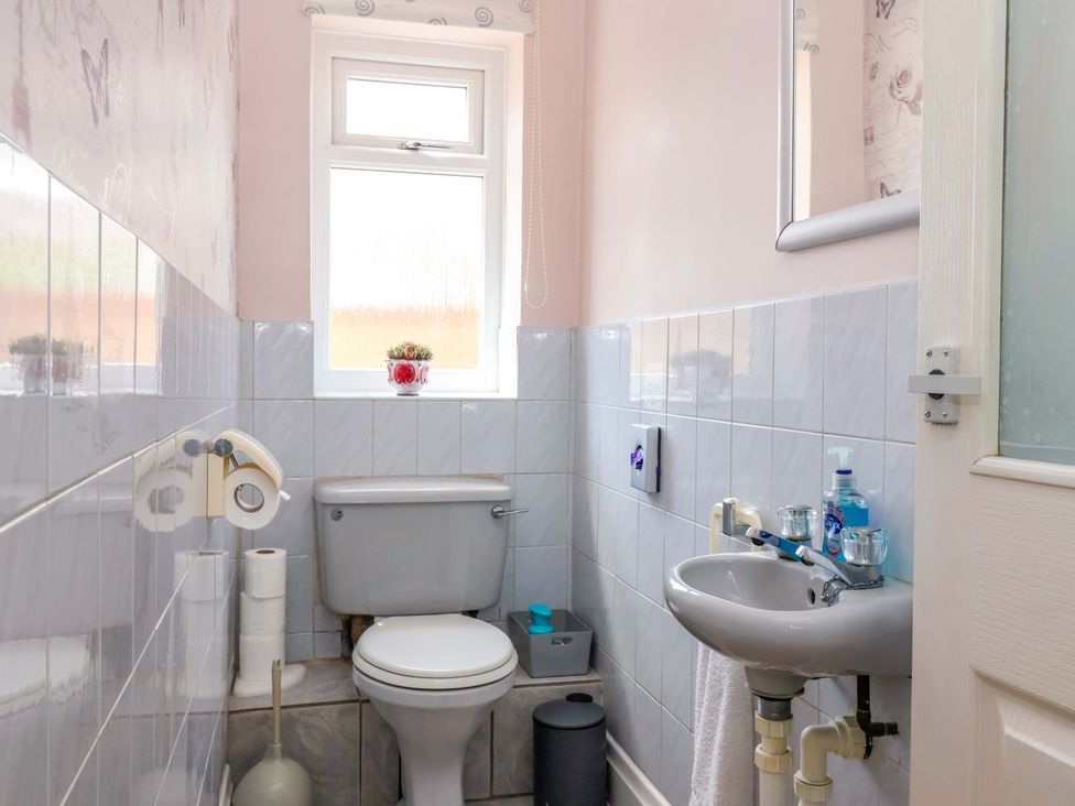 A bathroom with a toilet and wash basin at 3 Springhaven in Hampsthwaite