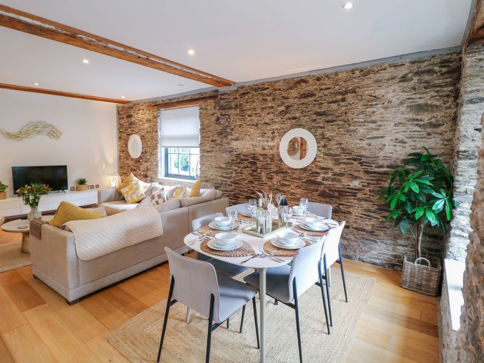 A dining area with a table set for meals at 9 The Pottery Dartmouth