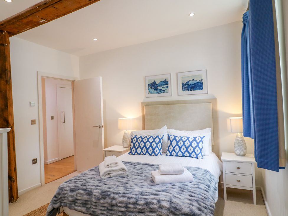 A bedroom with a bed and nightstands at 9 The Pottery in Dartmouth