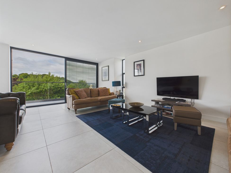 A living room with a sofa and television at Oakwood House in Tansley near Matlock