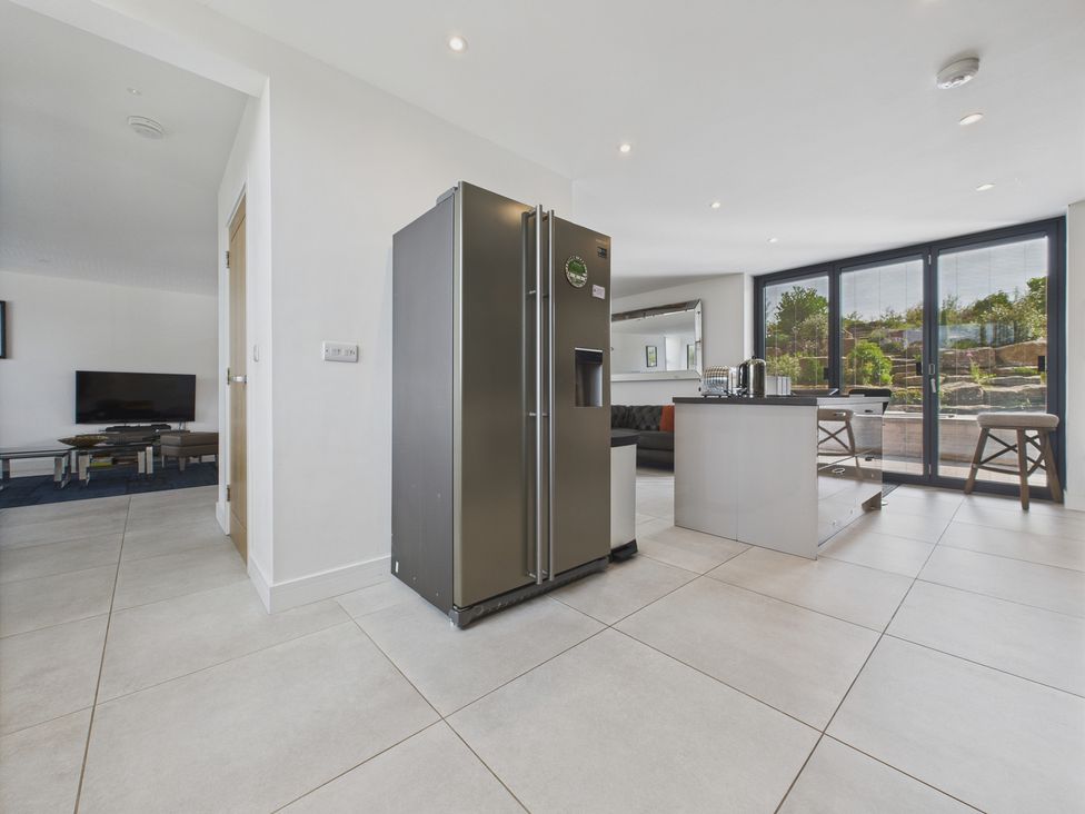A kitchen with refrigerator and kitchen island at Oakwood House Tansley near Matlock