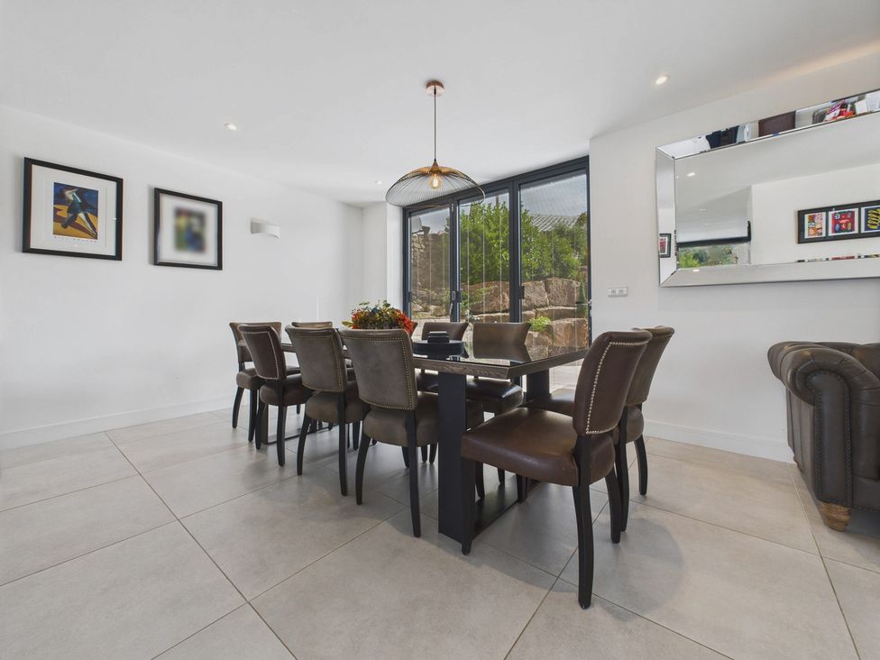 A dining room with a table and chairs at Oakwood House in Tansley near Matlock