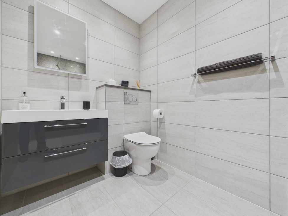 A bathroom with a sink and toilet at Oakwood House Tansley near Matlock