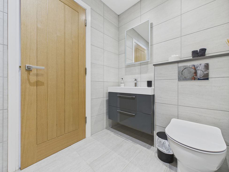 A bathroom with a sink and toilet at Oakwood House Tansley near Matlock