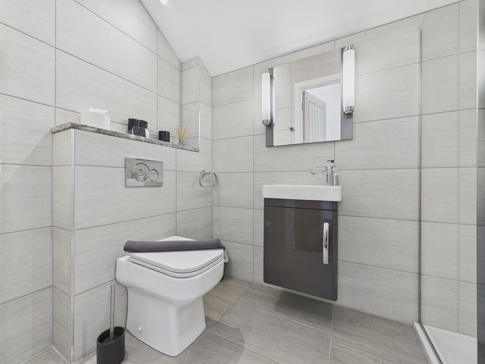 A bathroom with a sink and toilet at Oakwood House in Tansley near Matlock